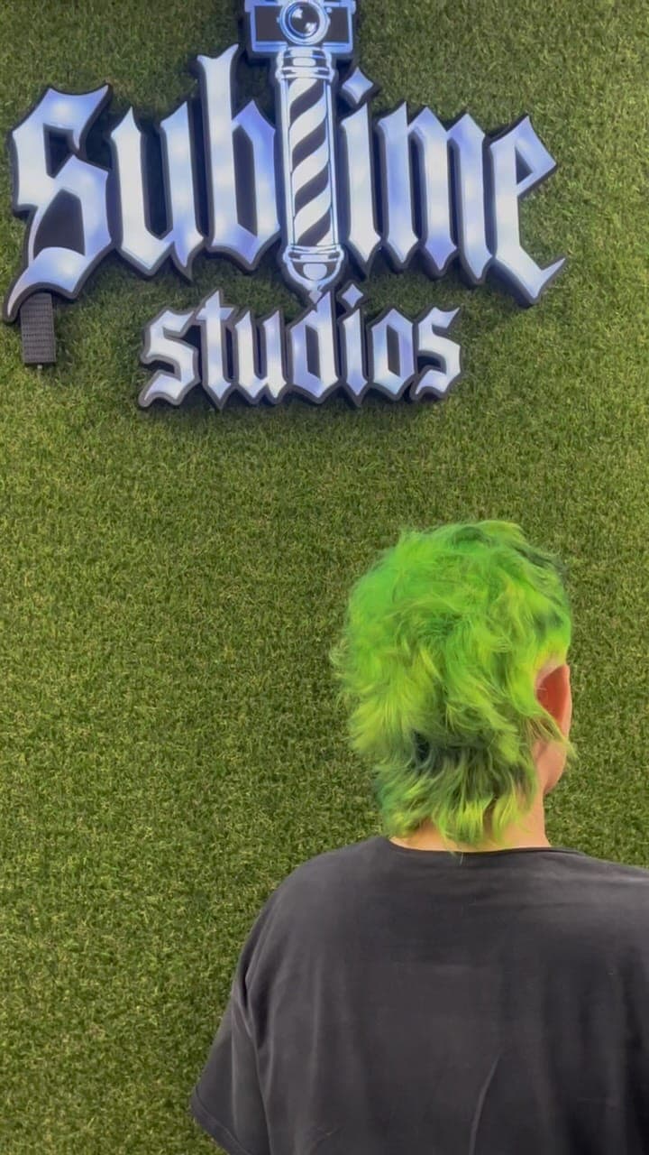 Vivid green mullet in front of the Sublime Studios sign