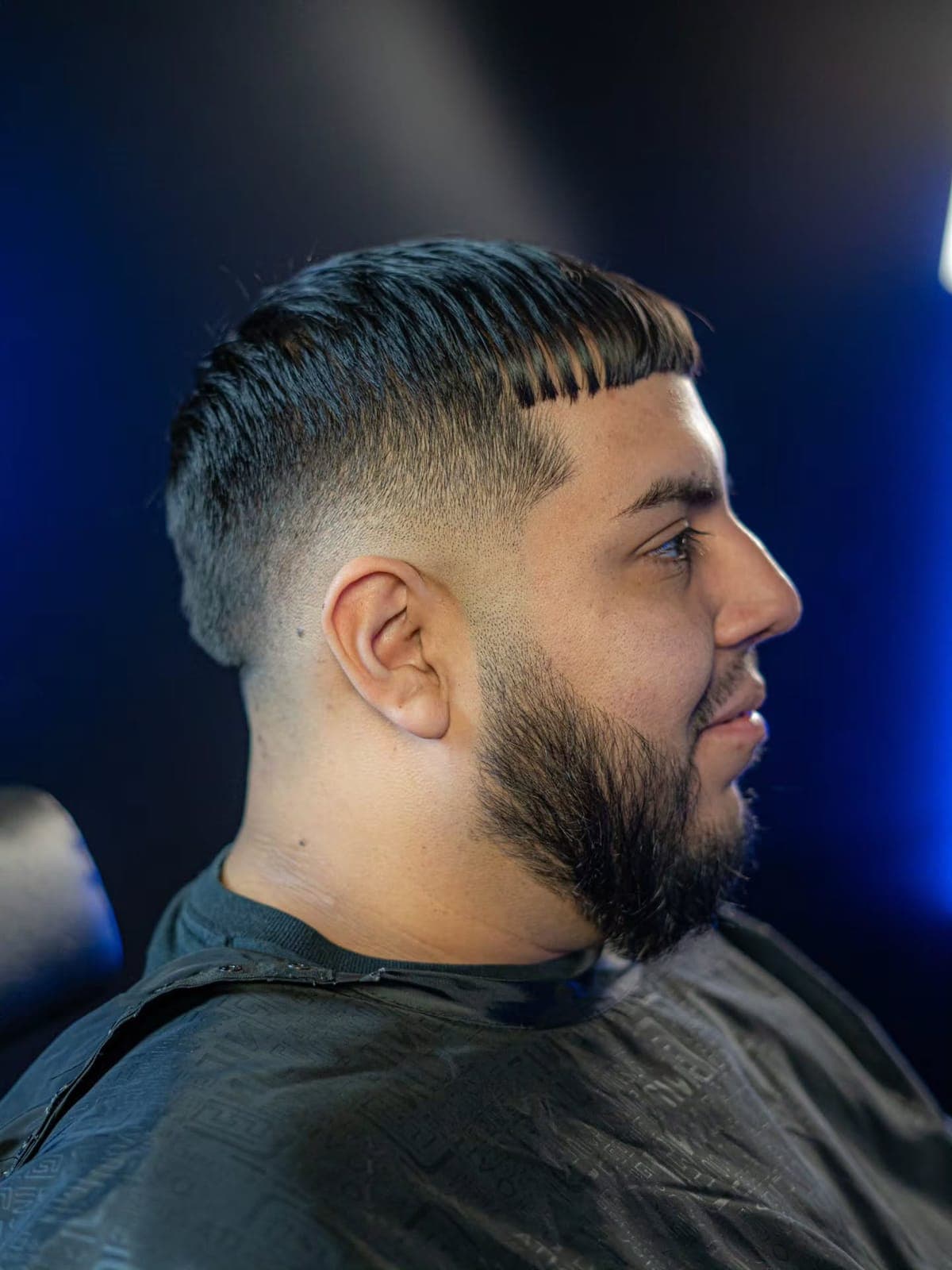 Fade and beard under blue studio light