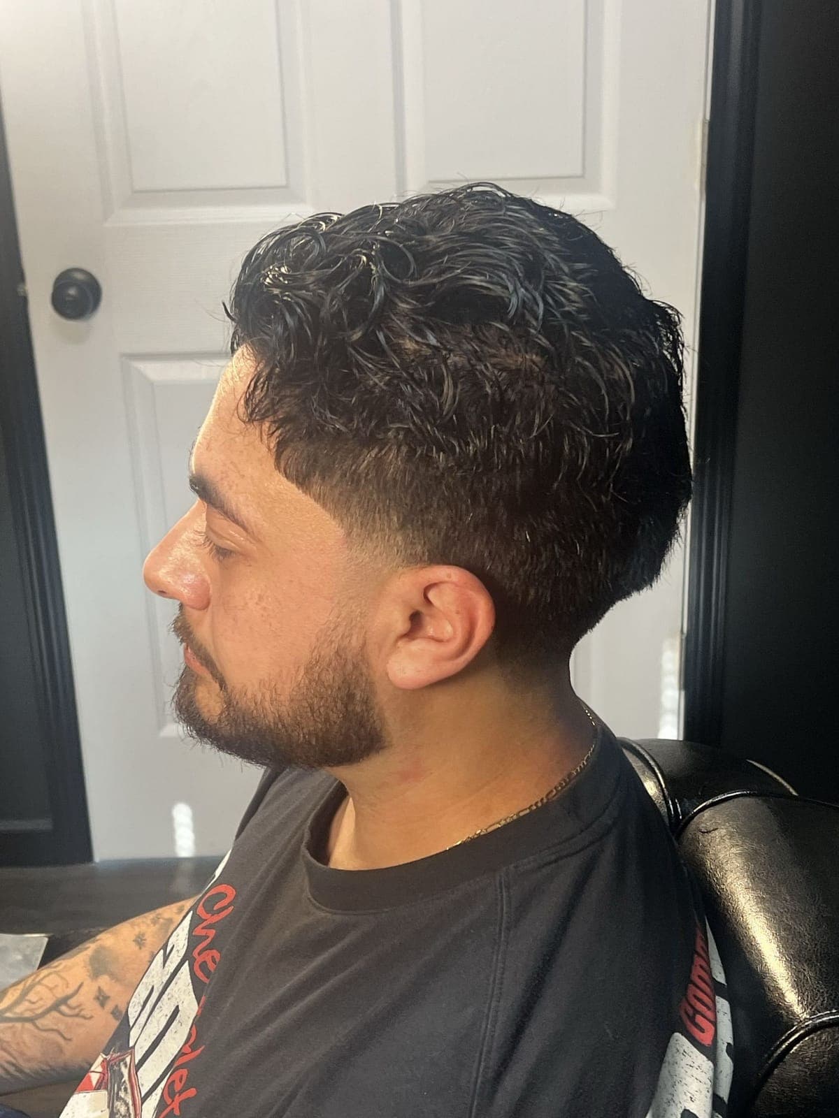 Curly top with a taper and beard